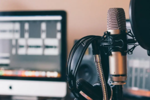 Microphone, headphones and recording equipment in a podcast studio